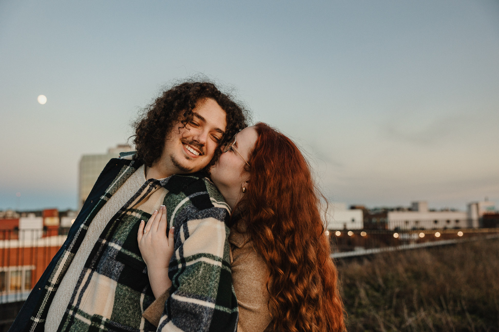 A couple embracing warmly during a downtown Sudbury couples session